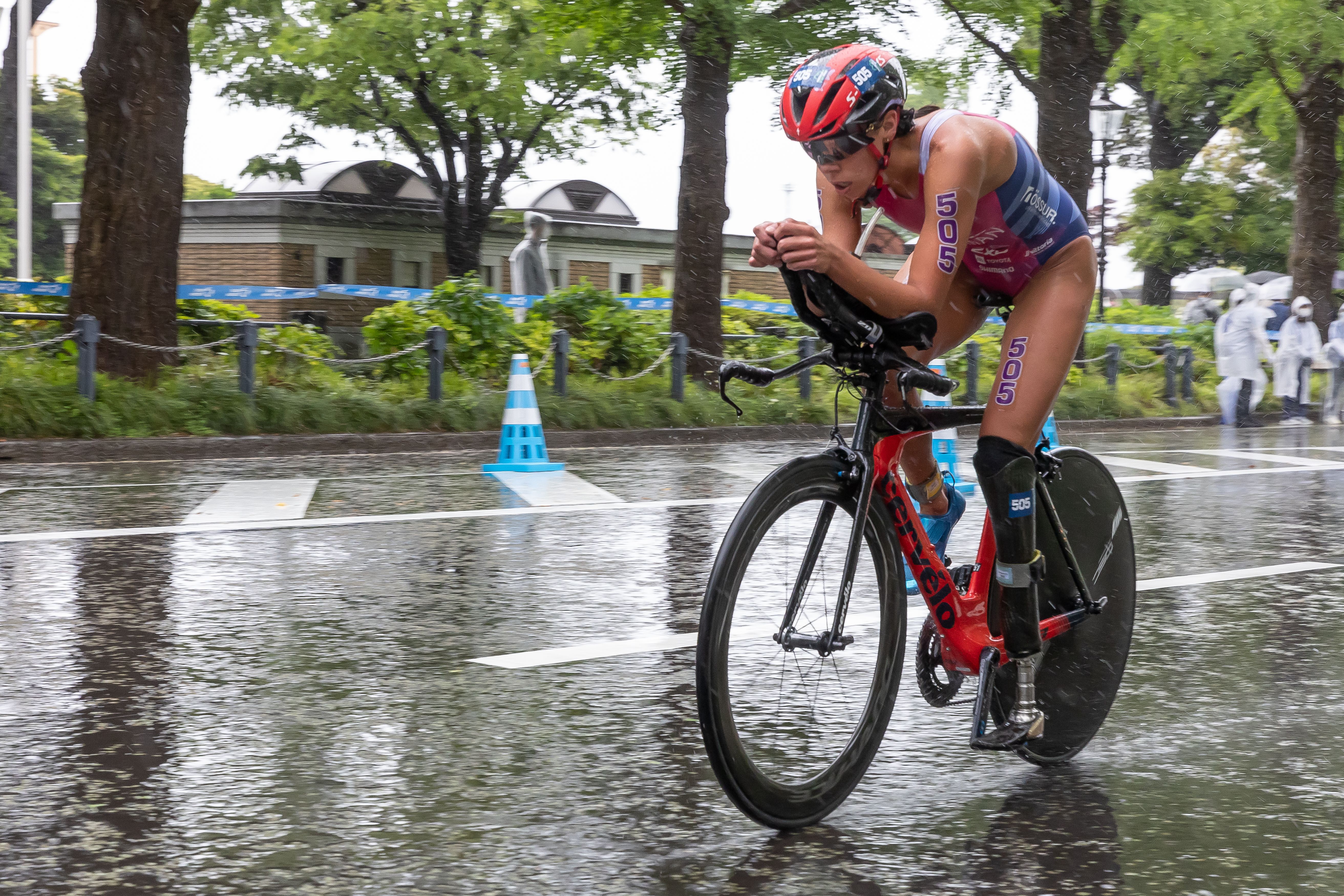 Grace Norman bicycles down a street during a paratriathlon event. 