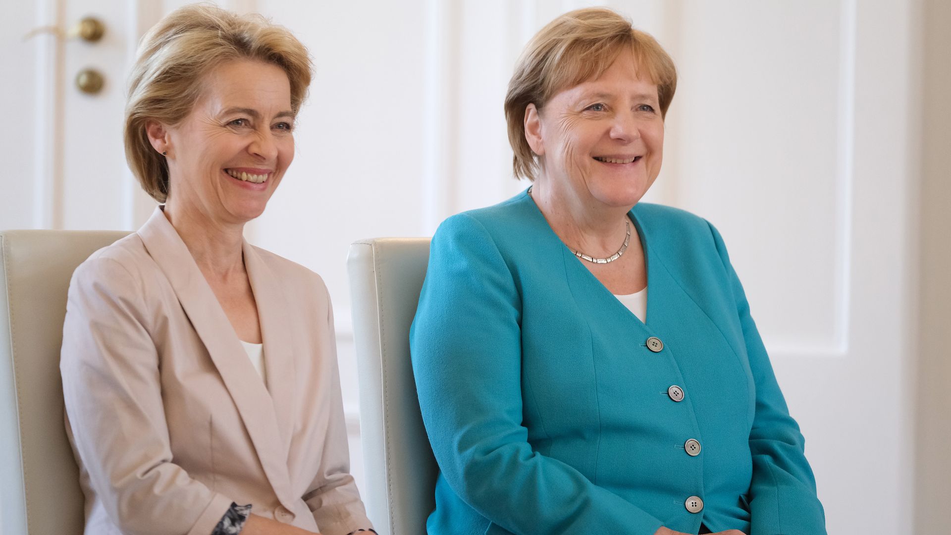 Ursula von der Leyen seated next to Angela Merkel