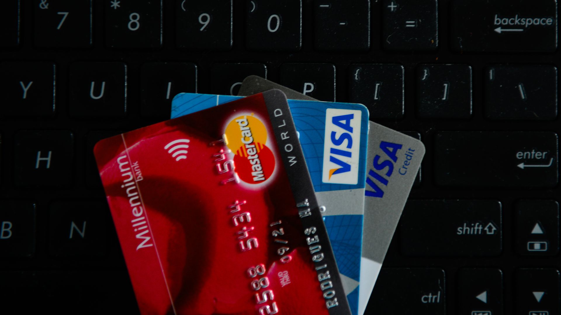 VISA and Mastercards credit cards are seen on the top of a laptop keyboard