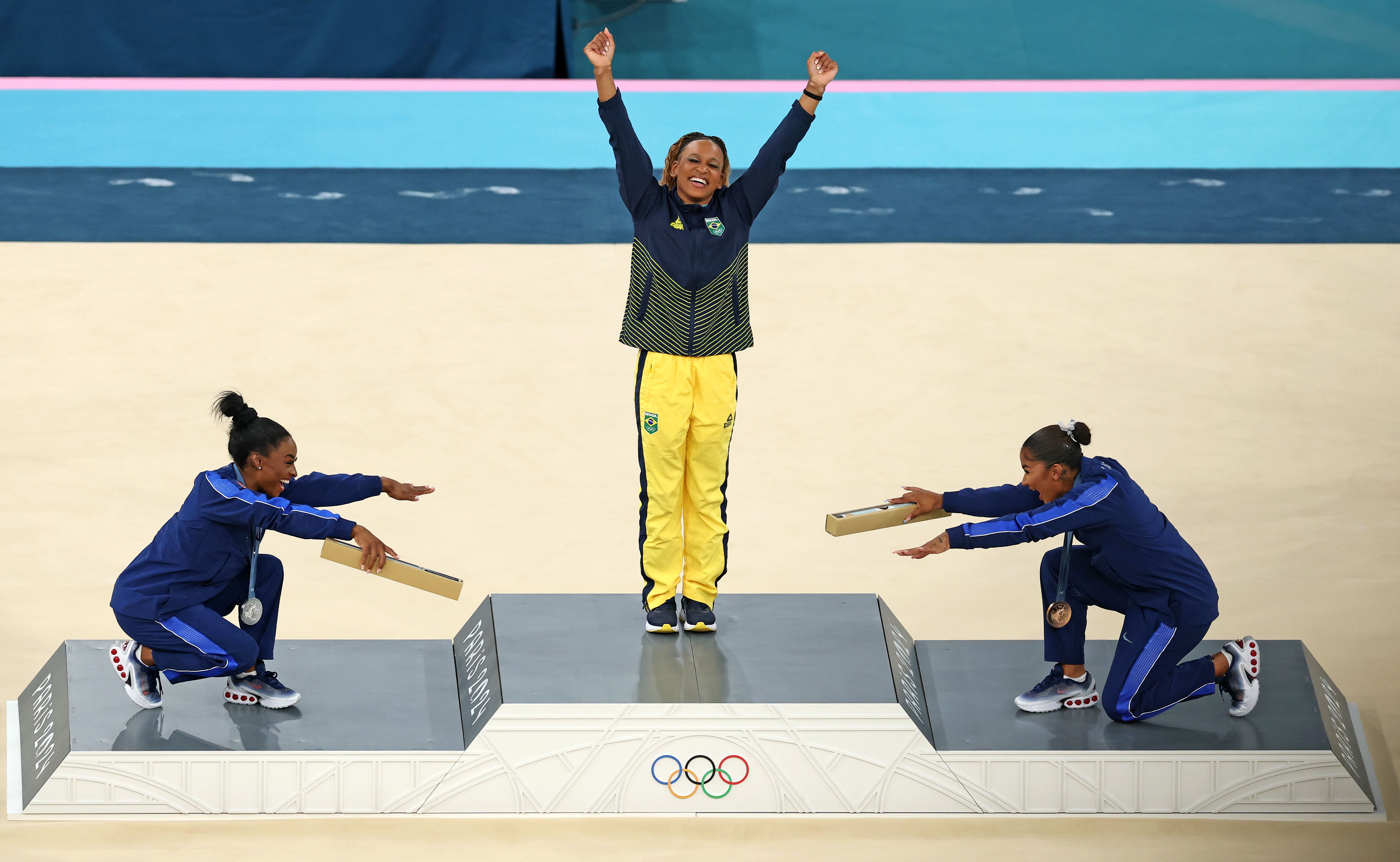 Gold medalist Rebeca Andrade (C) of Team Brazil, silver medalist Simone Biles (L) of Team United States and bronze medalist Jordan Chiles