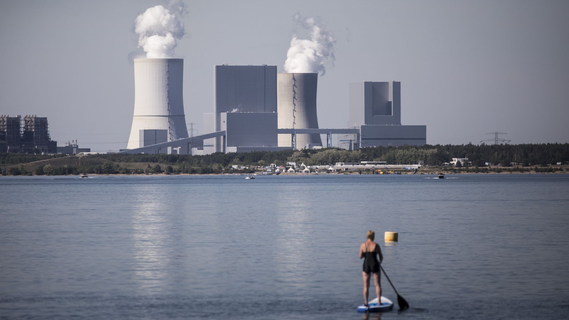 Someone looks on at plant emitting gas.