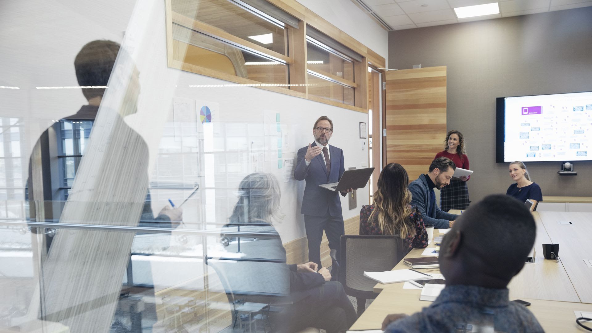 A man giving a presentation to people at his company