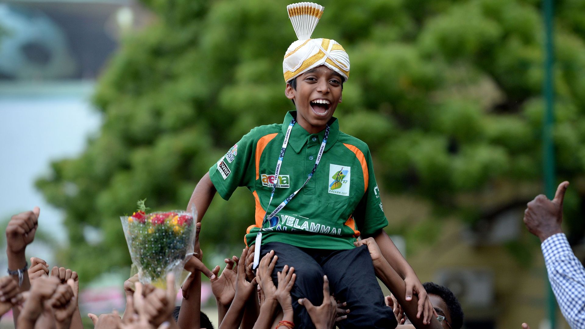  Indian chess prodigy Rameshbabu Praggnanandhaa, 12, laughs as he is celebrated by his school friends upon his arrival back to his school in Chennai on June 26, 2018 