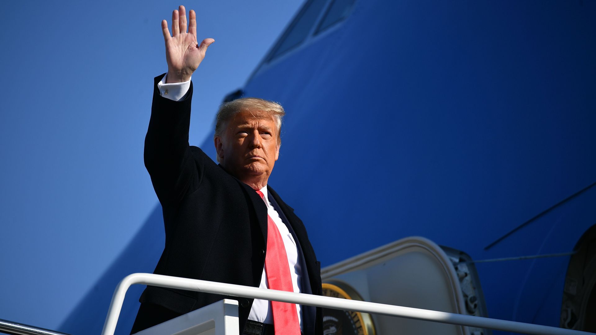 Former President Trump is seen waving goodbye before boarding Air Force One.
