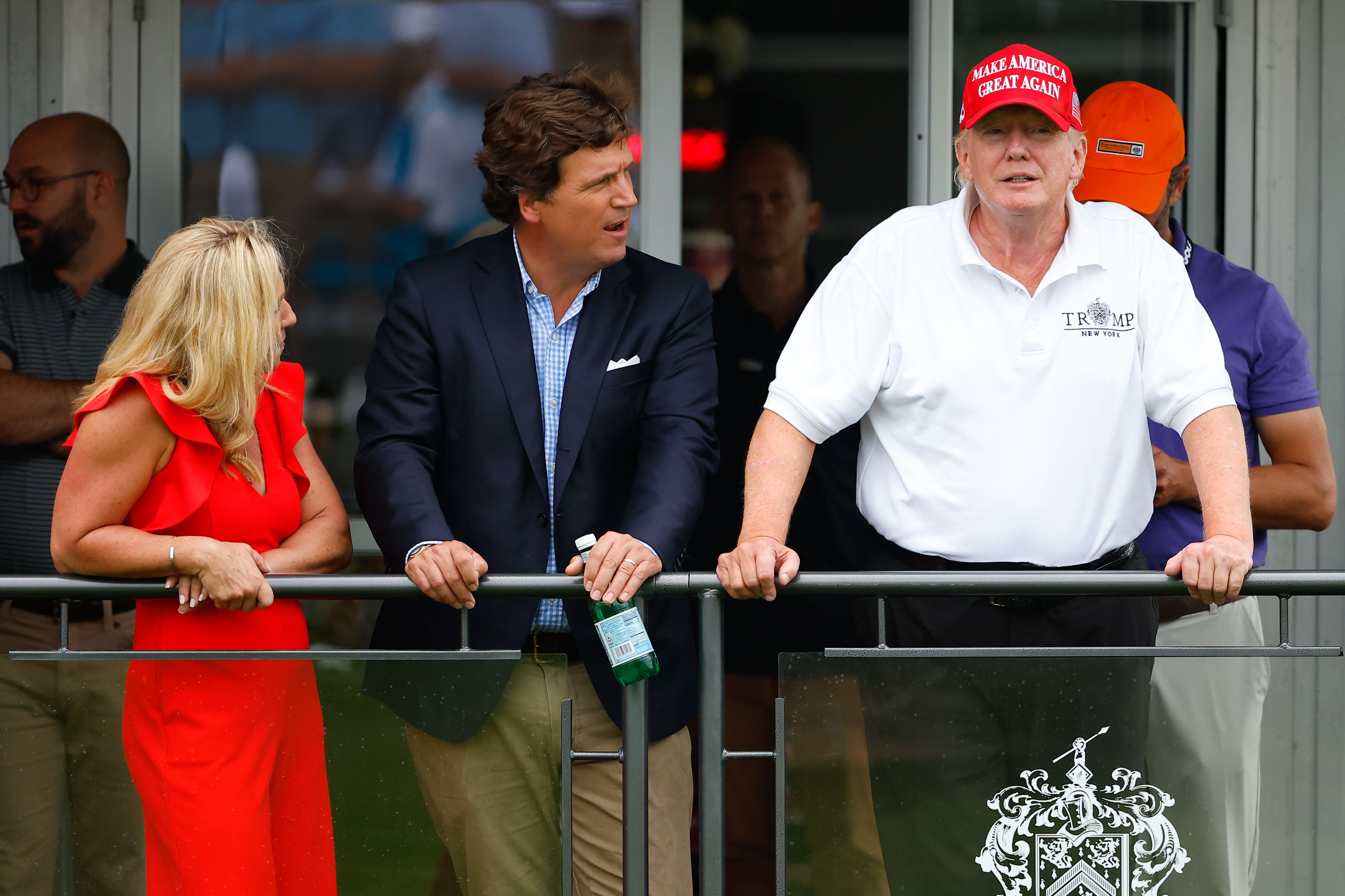 Tucker Carlson at a golf event with former President Trump and Rep.  Marjorie Taylor Greene.