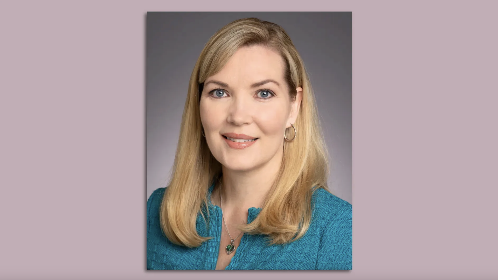 Portrait of Nicole Mitchell against a gray background.
