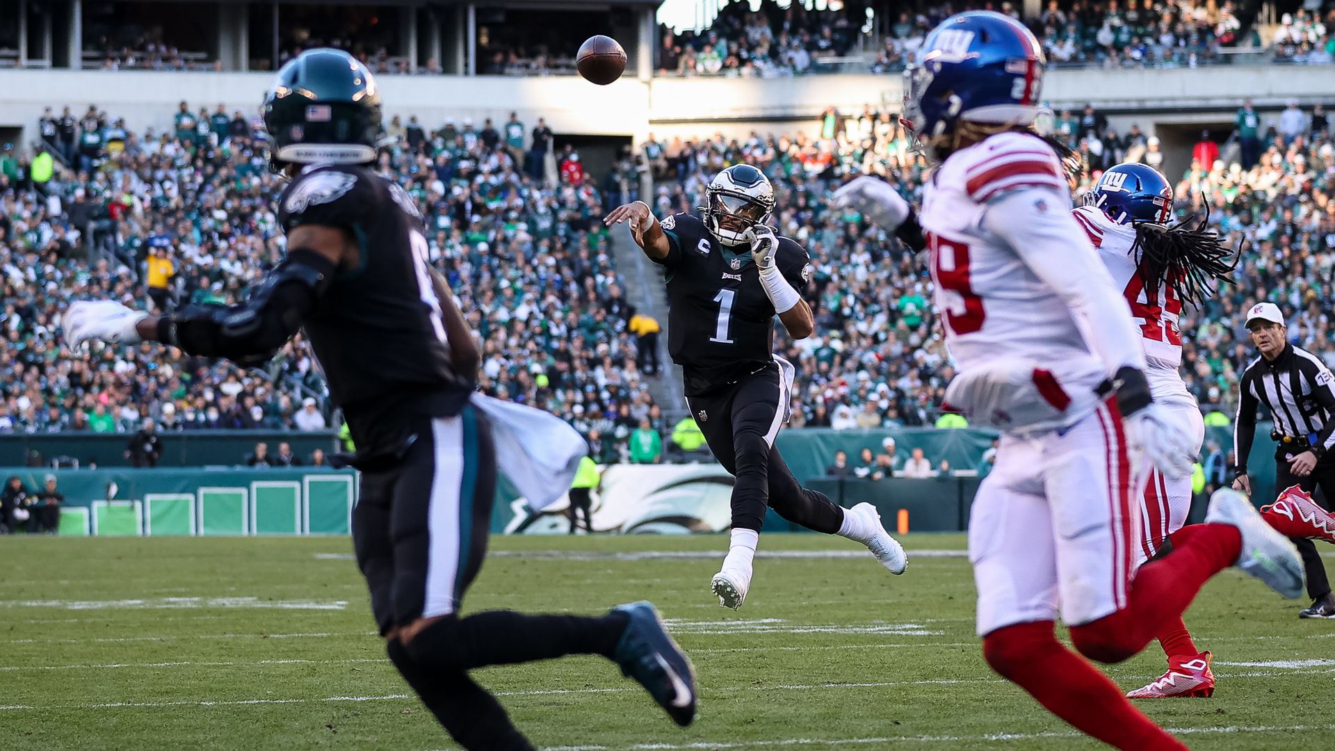 Jalen Hurts #1 of the Philadelphia Eagles throws a pass for a touchdown to DeVonta Smith #6 against the New York Giants during the second half at Lincoln Financial Field.