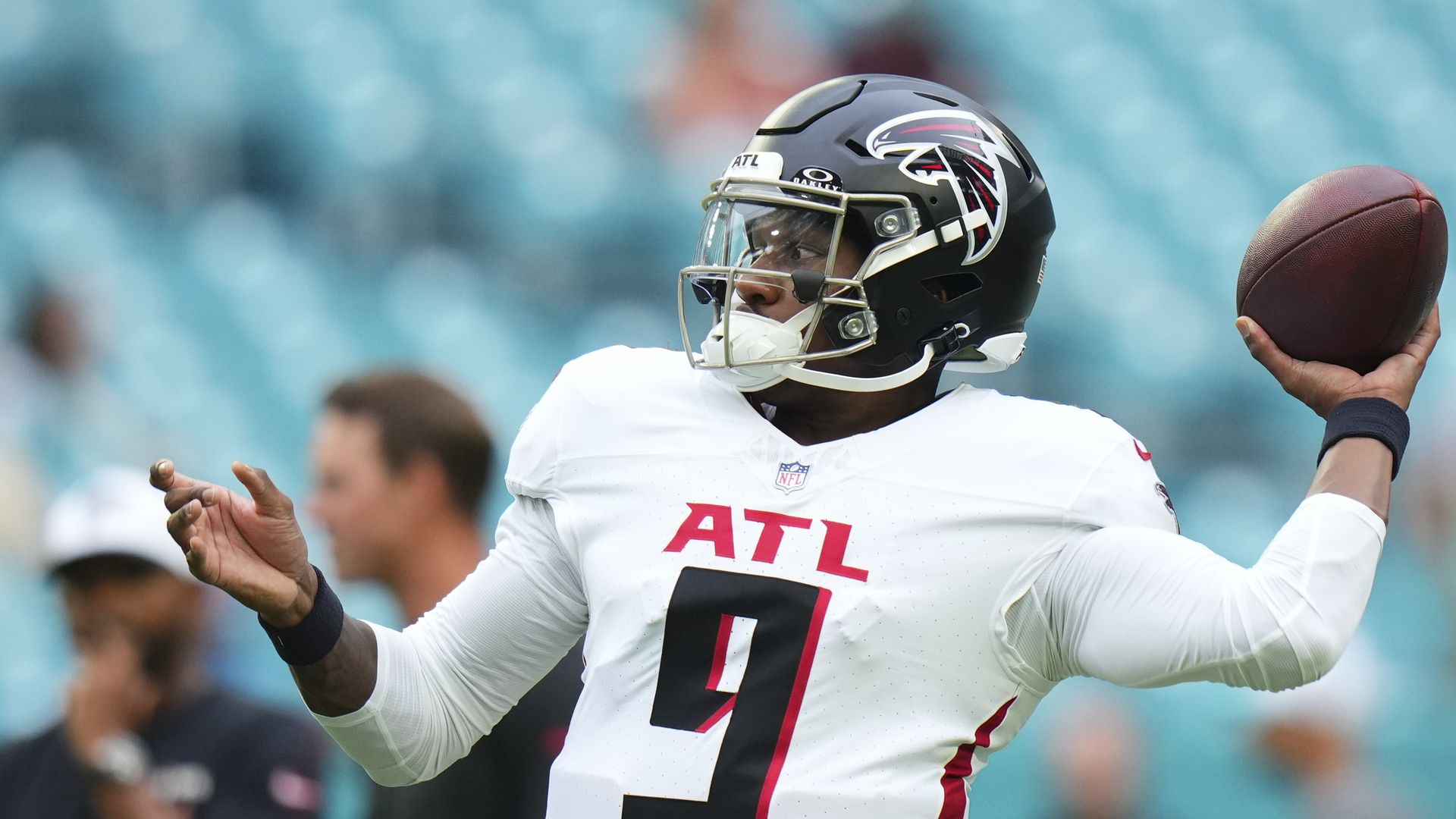 Player throws a football while wearing a white uniform with the letters ATL and the number nine