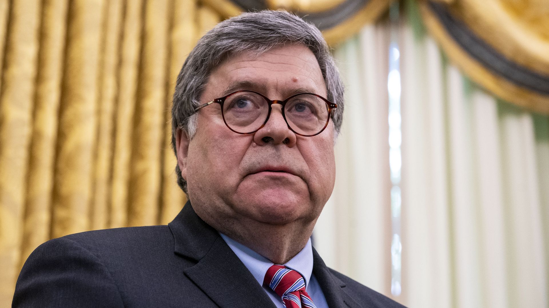 Bill Barr stands in this image