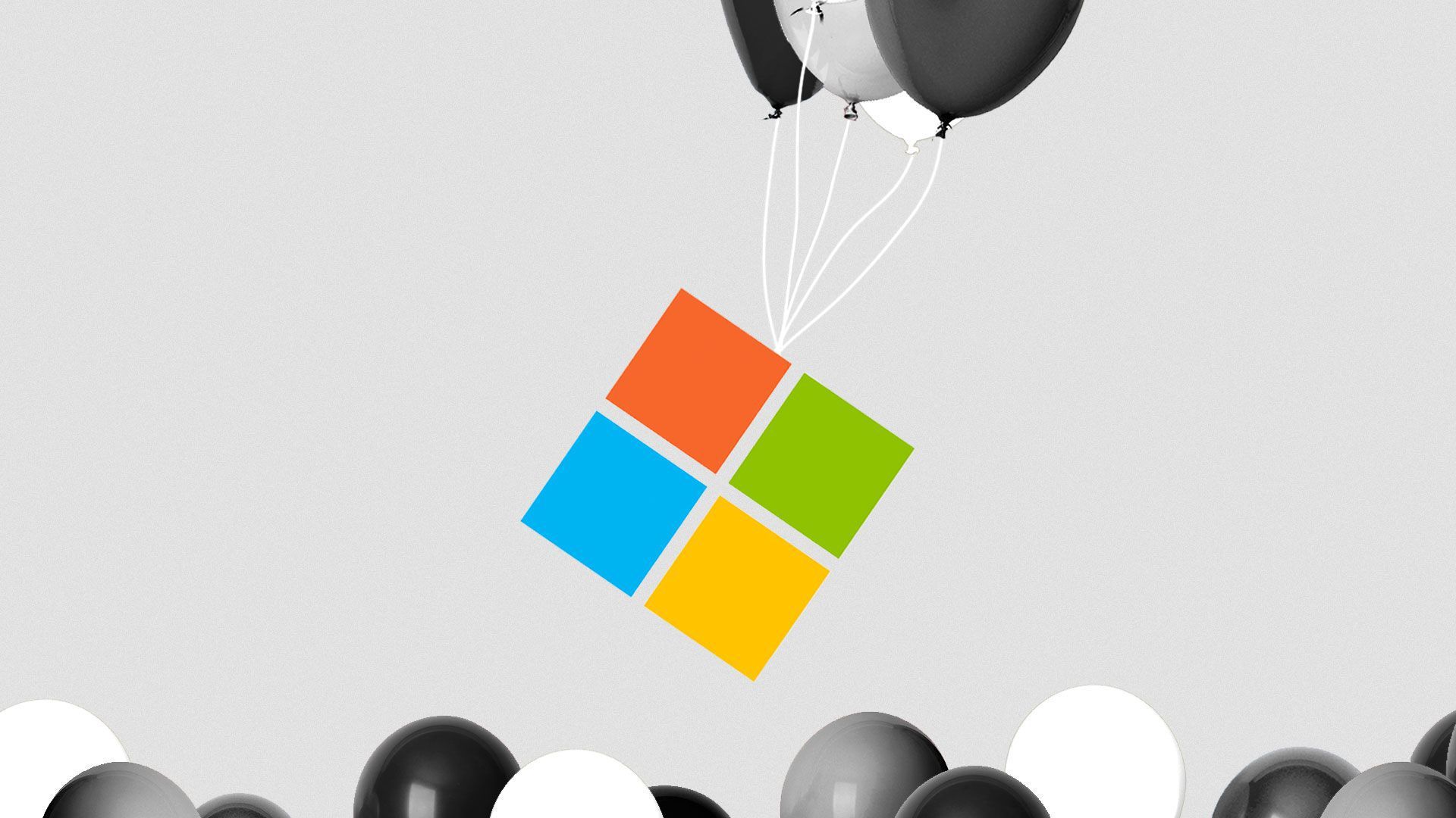An image of the Microsoft logo being lifted by balloons.