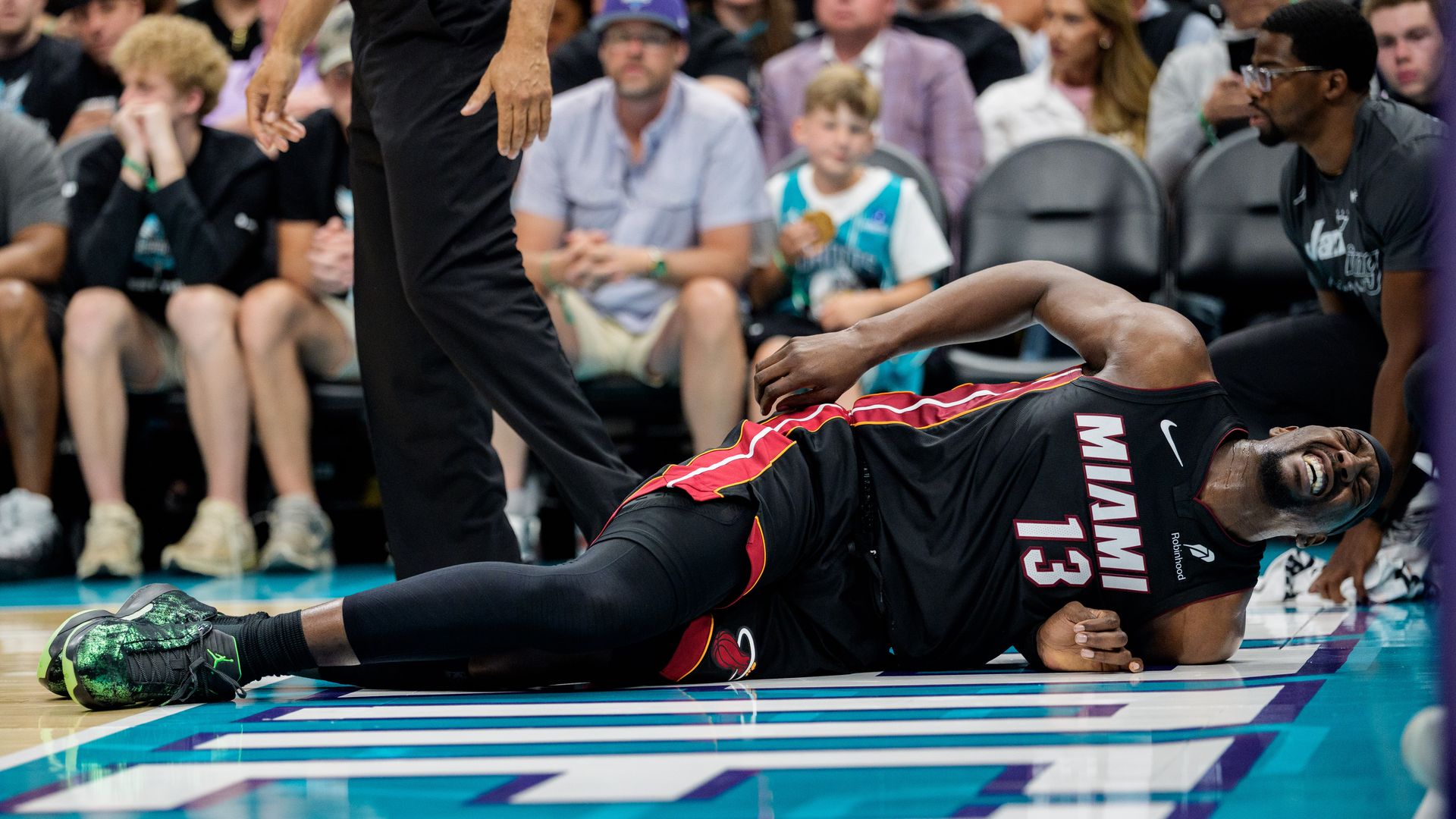 CHARLOTTE, NORTH CAROLINA - APRIL 14: Bam Adebayo #13 of the Miami Heat reacts after a fall in the first half against the Charlotte Hornets during their game at Spectrum Center on April 14, 2026 in Charlotte, North Carolina. NOTE TO USER: User expressly acknowledges and agrees that, by downloading a
