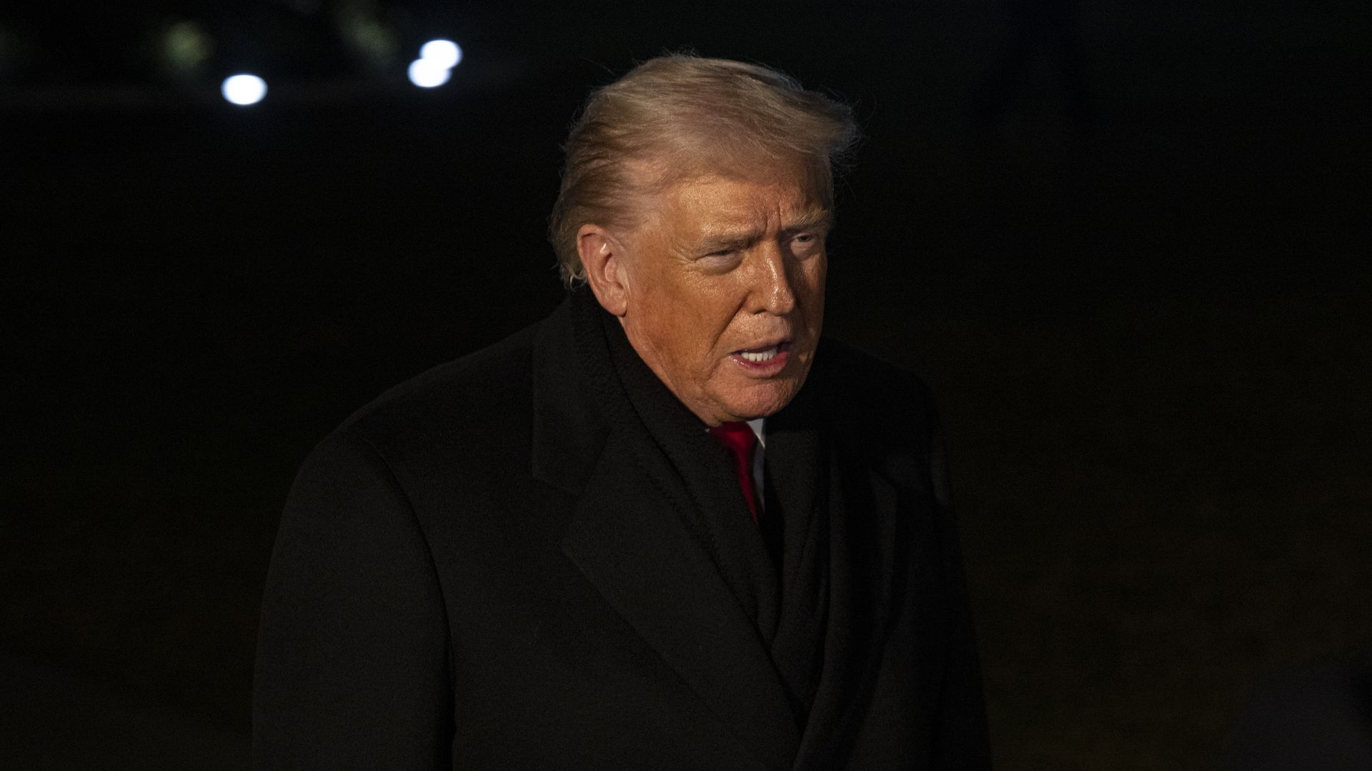Donald Trump speaks to reporters outside the White House before a planned trip to Davos, Switzerland.