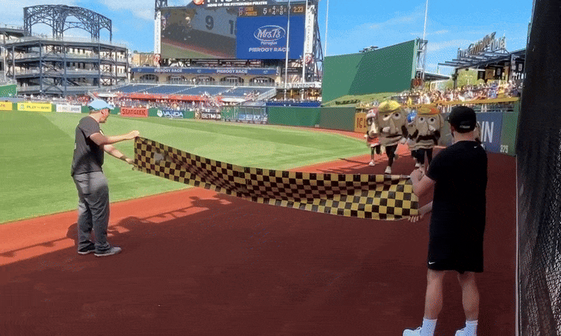 The pierogies racing at PNC Park. Cheese Chester sprints through the black and yellow tape to win.