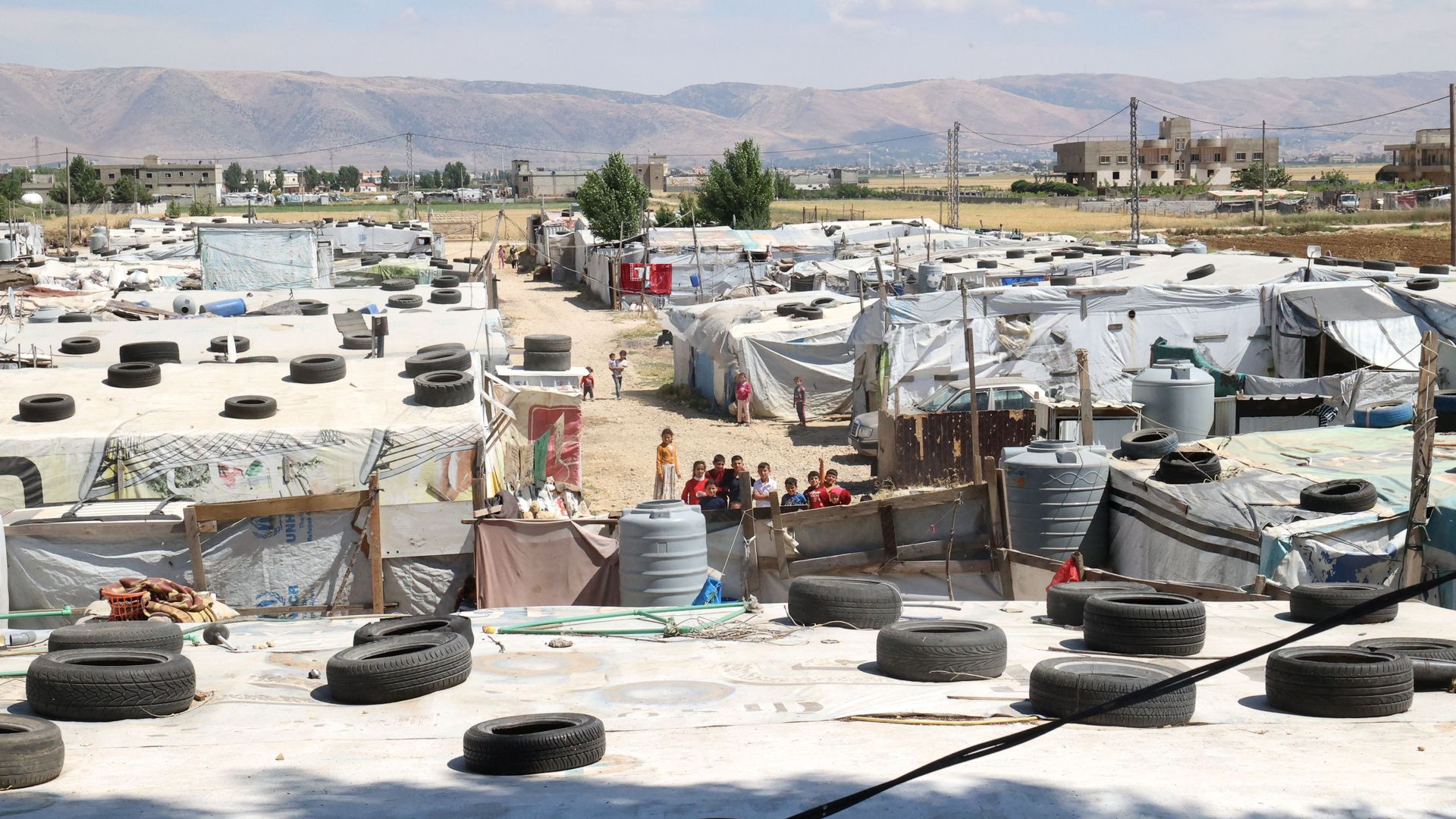 Syrian children gather between tents at a refugee camp in Saadnayel in eastern Lebanon