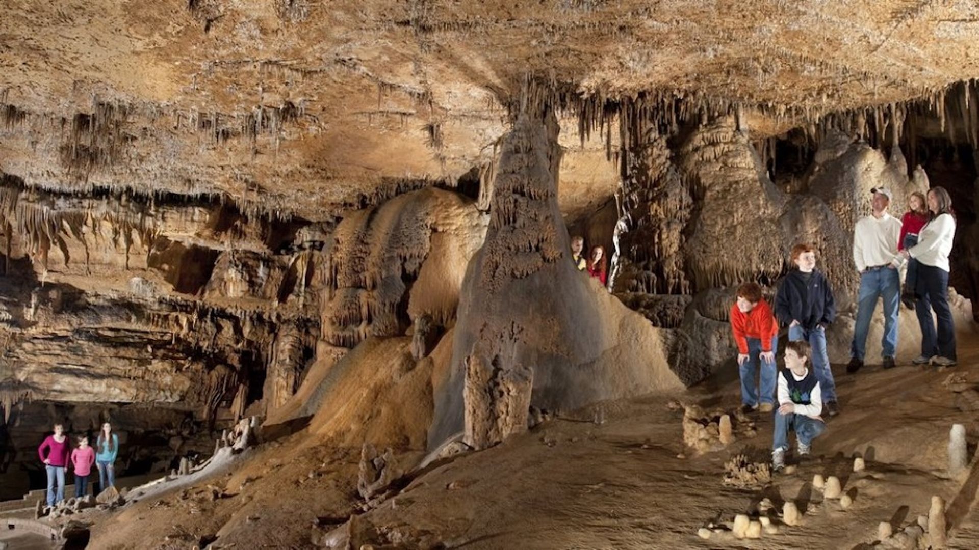Families standing inside indoor caves.