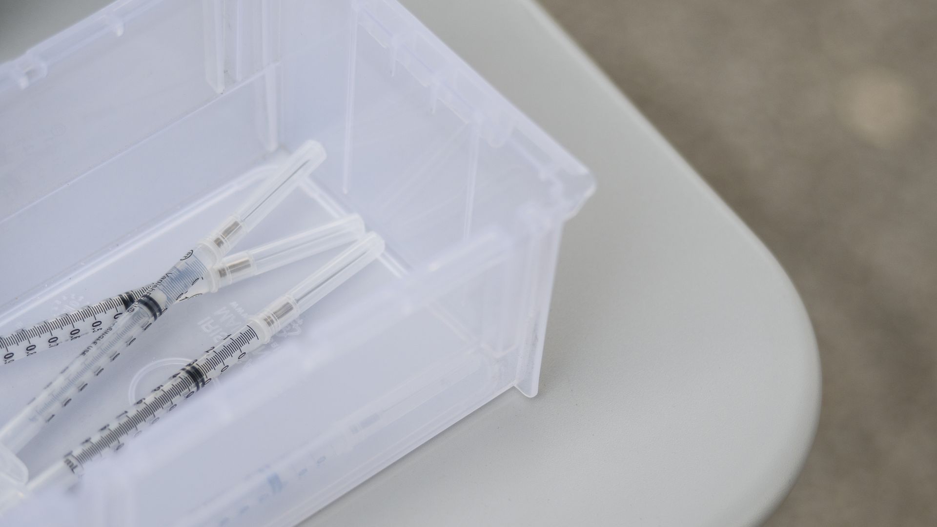 A photo of COVID vaccines in a bin.