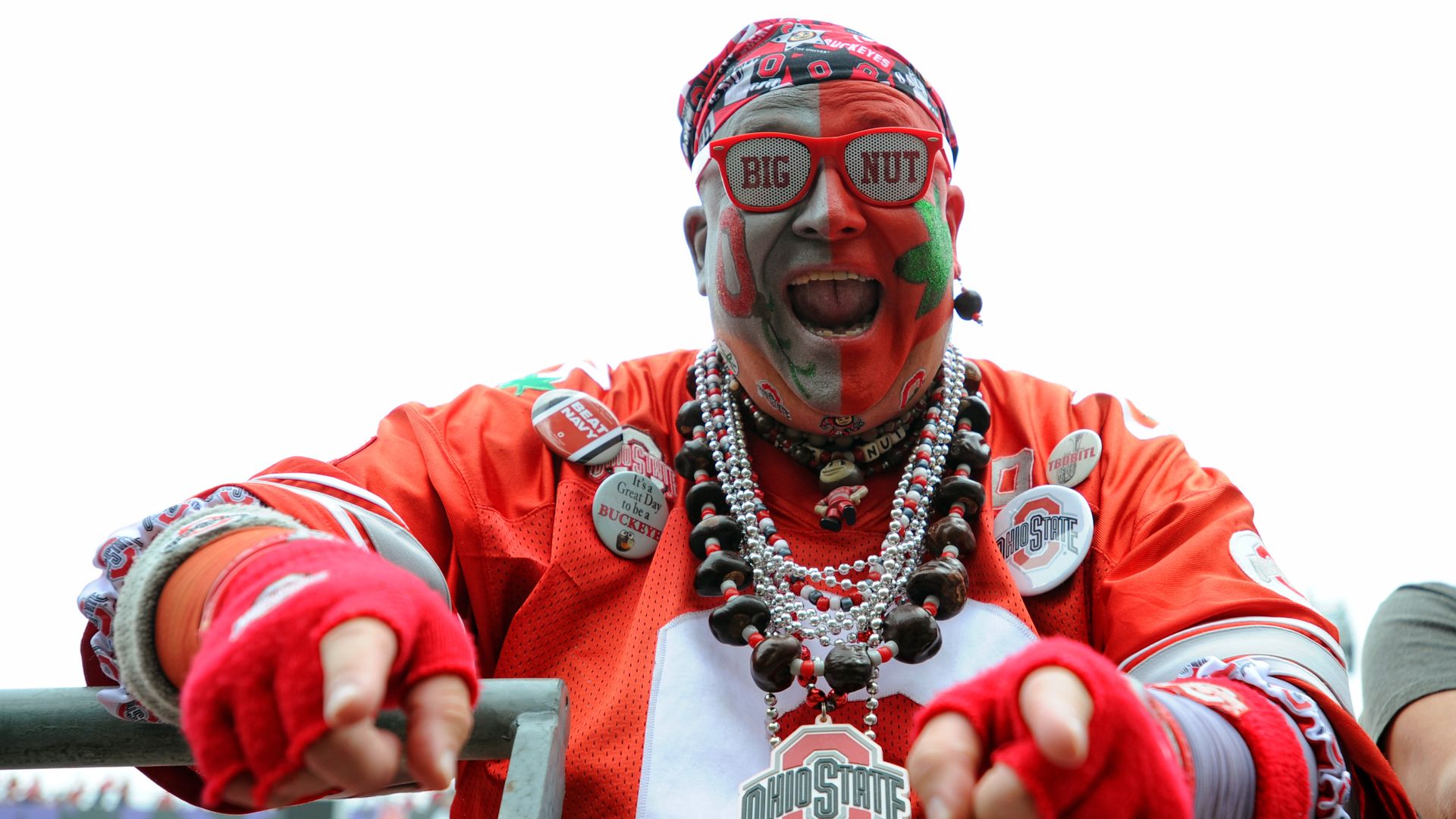 Photo of a man dressed in sports gear with his face painted. 