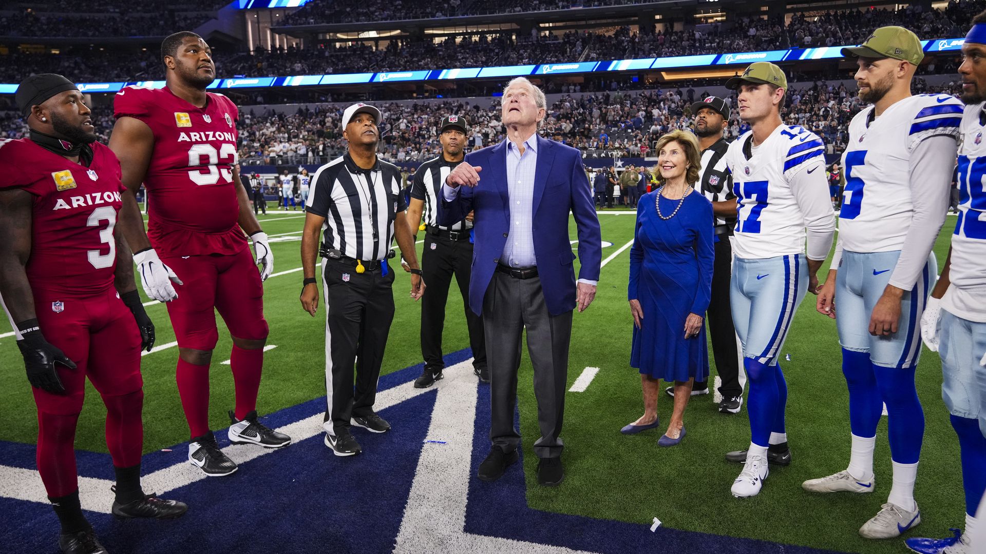 President George W. Bush tosses a coin on a field