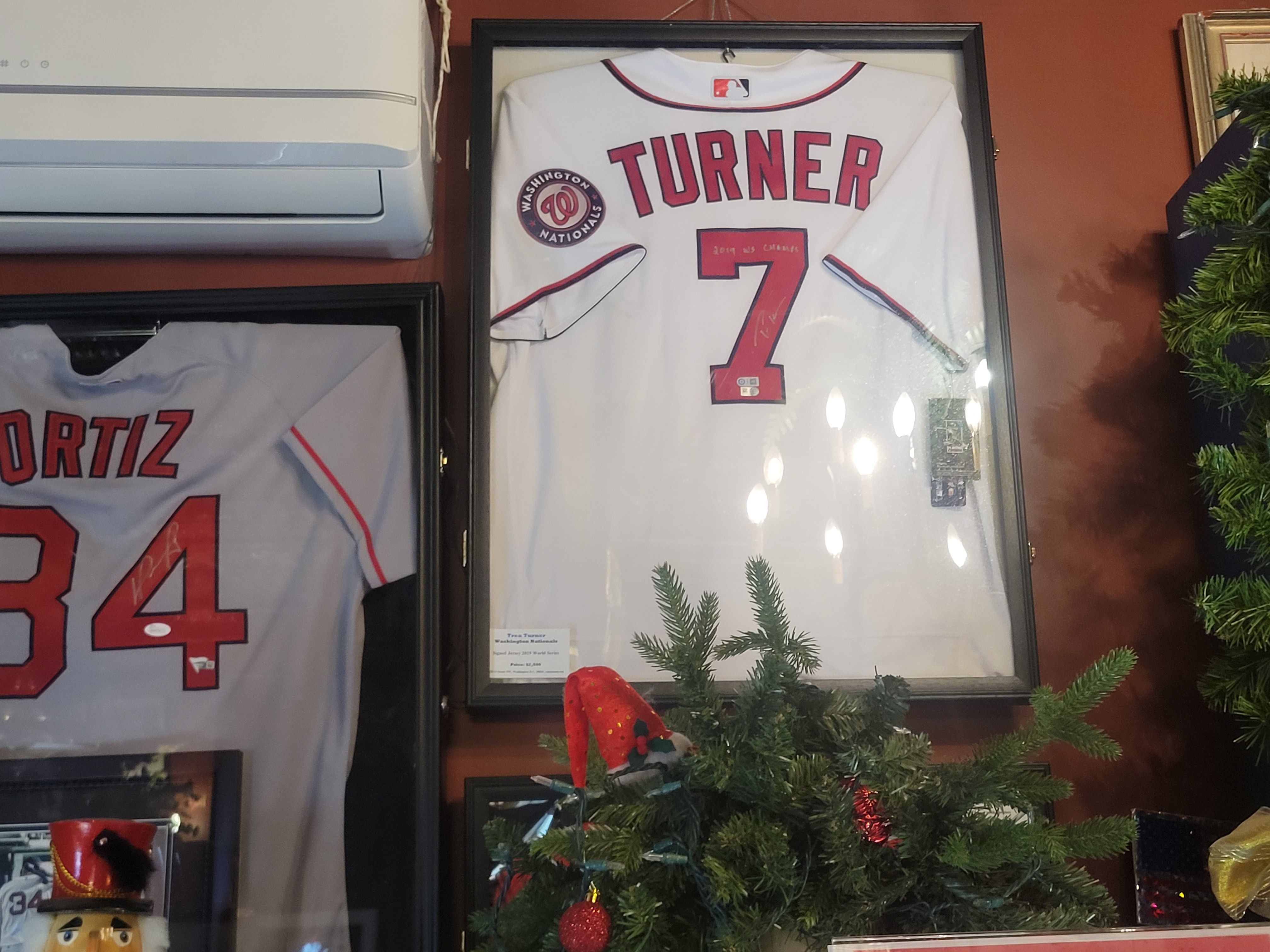 Framed white Washington Nationals baseball jersey of Trea Turner, now with the Phillies. 