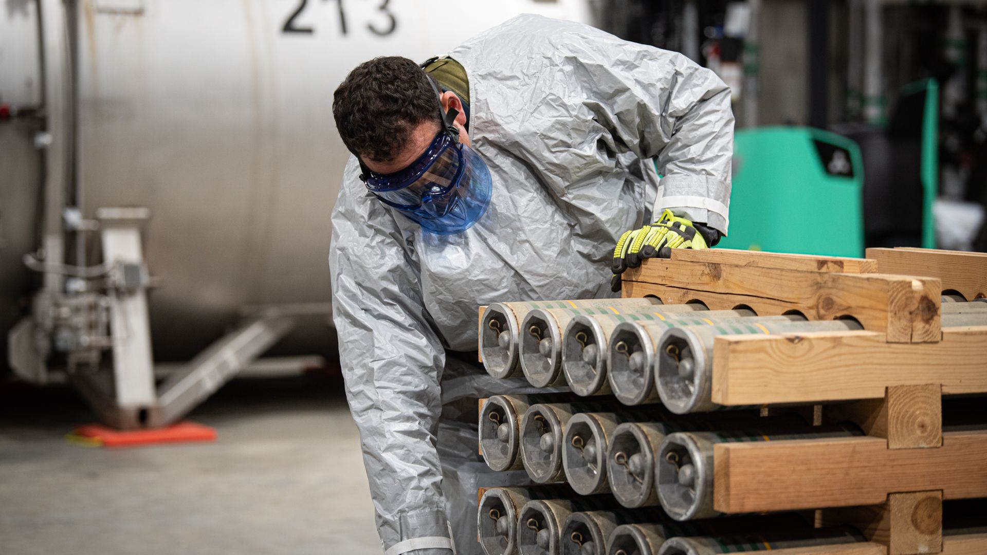 An worker removing rockets from a pallet at the Blue Grass Chemical Agent-Destruction Pilot Plant.