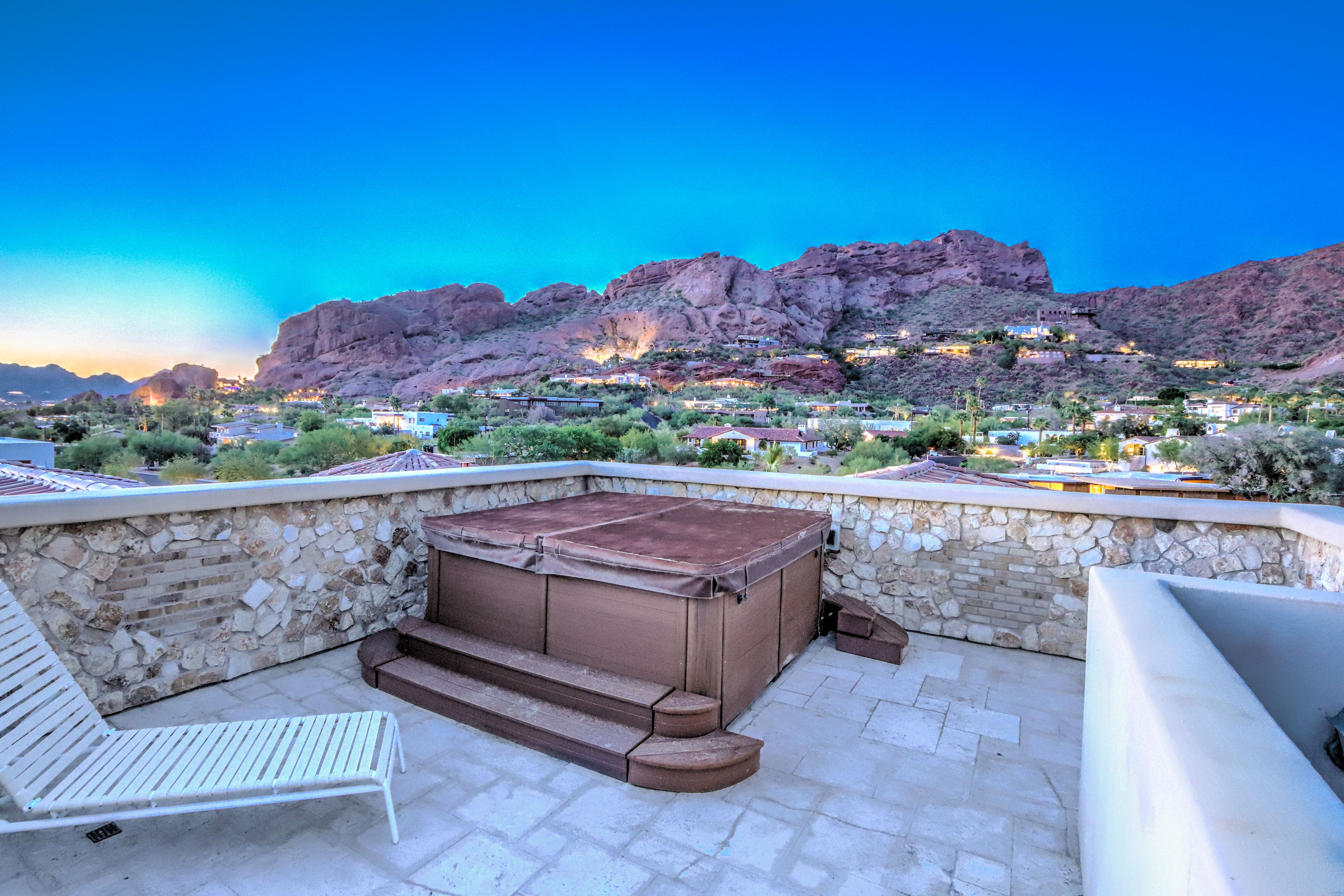 A rooftop hot tub overlooking a mountain. 