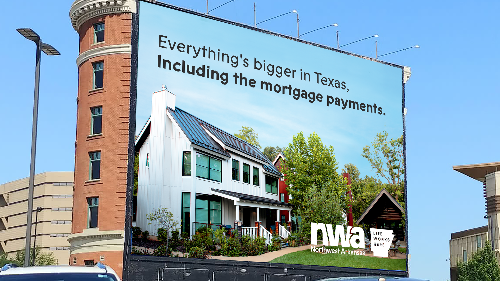 A billboard that reads "everything's bigger in Texas, including the mortgage payments."