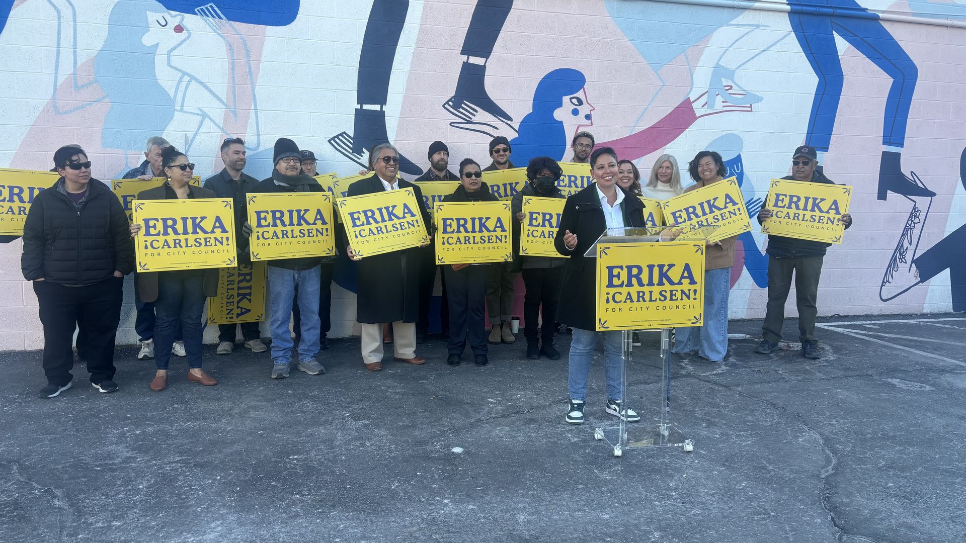 Erika Carlsen launches her city council campaign in front of a mural.