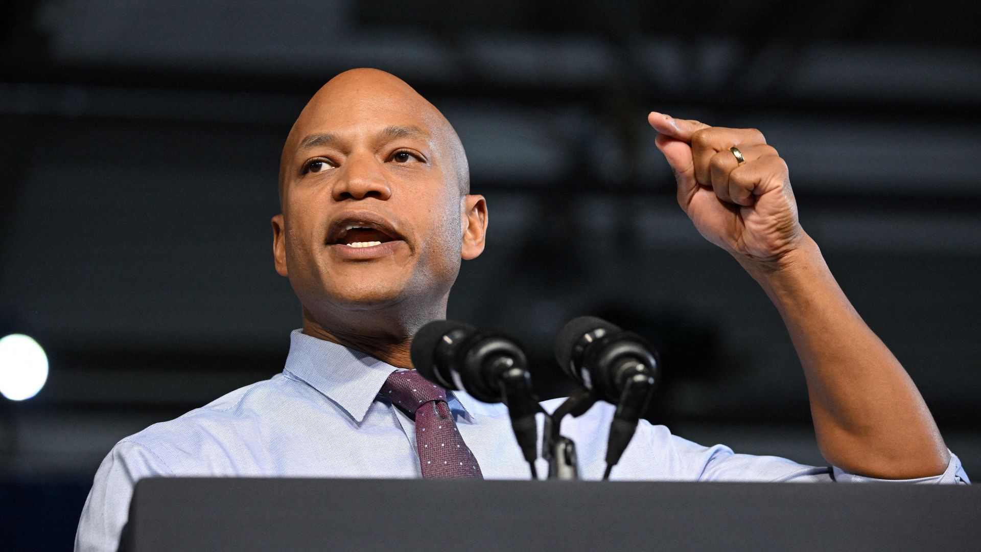 Photo of Wes Moore speaking while raising his hand