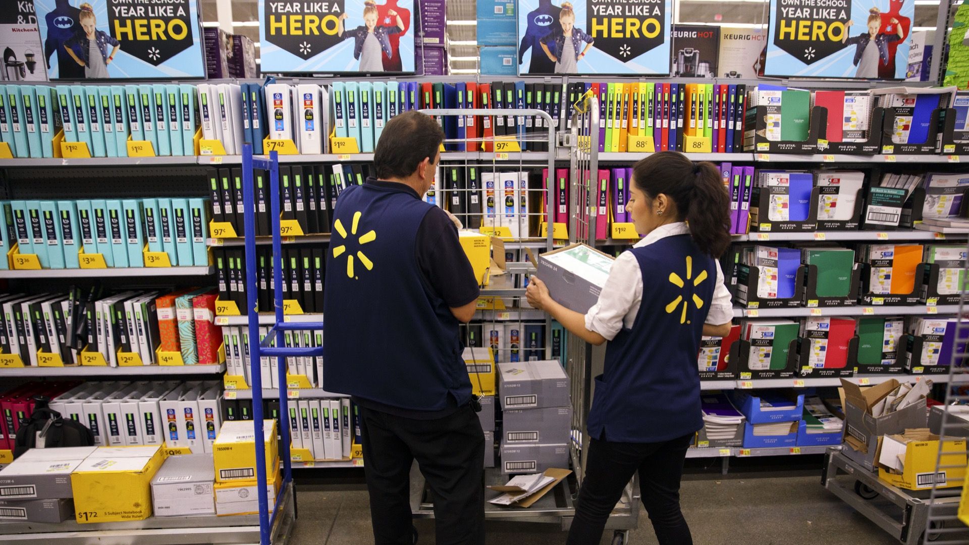 Walmart employees stock shelves.