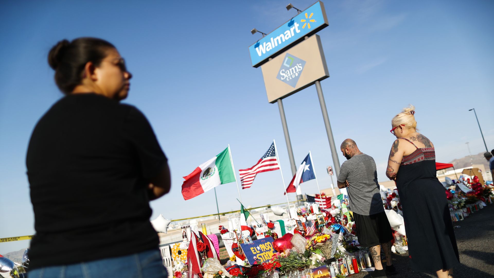 People gather in front of a Walmart in El Paso to remember the victims of a mass shooting