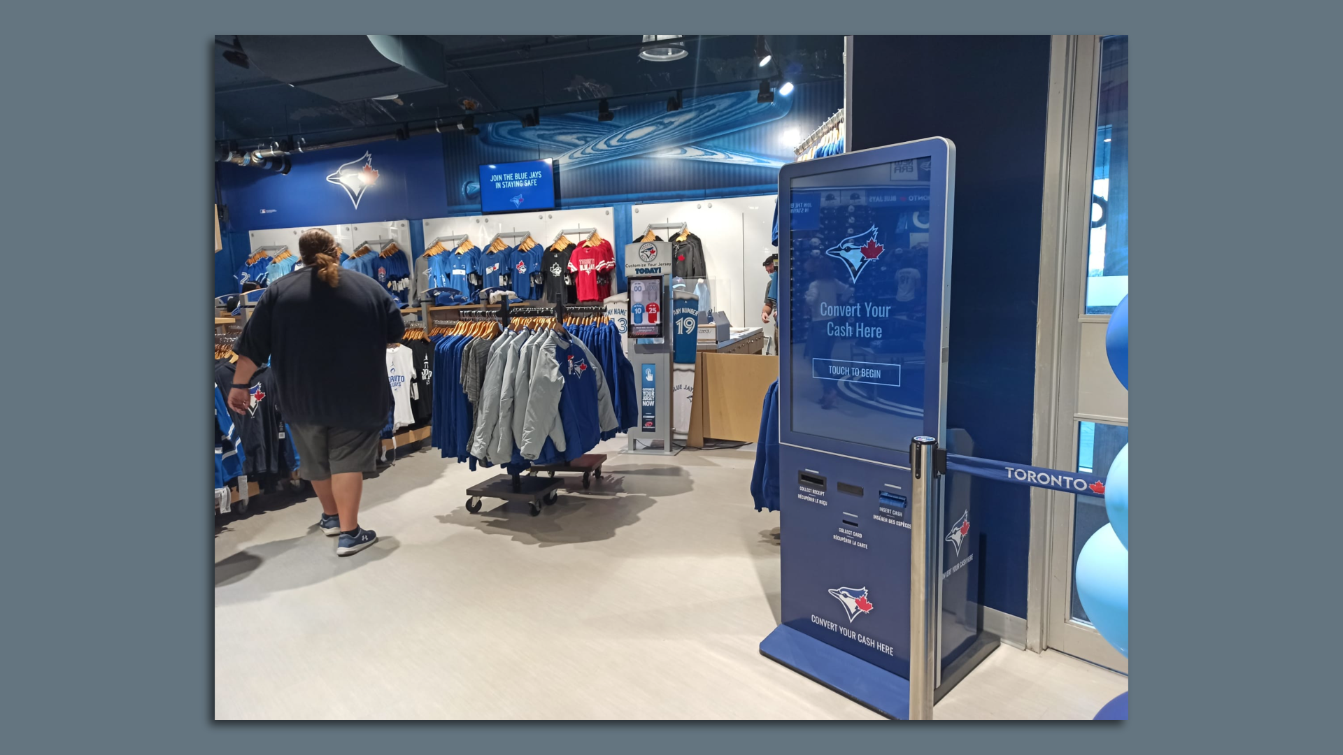 A "reverse ATM," which accepts cash and dispenses stored value cards, is shown in a retail store.