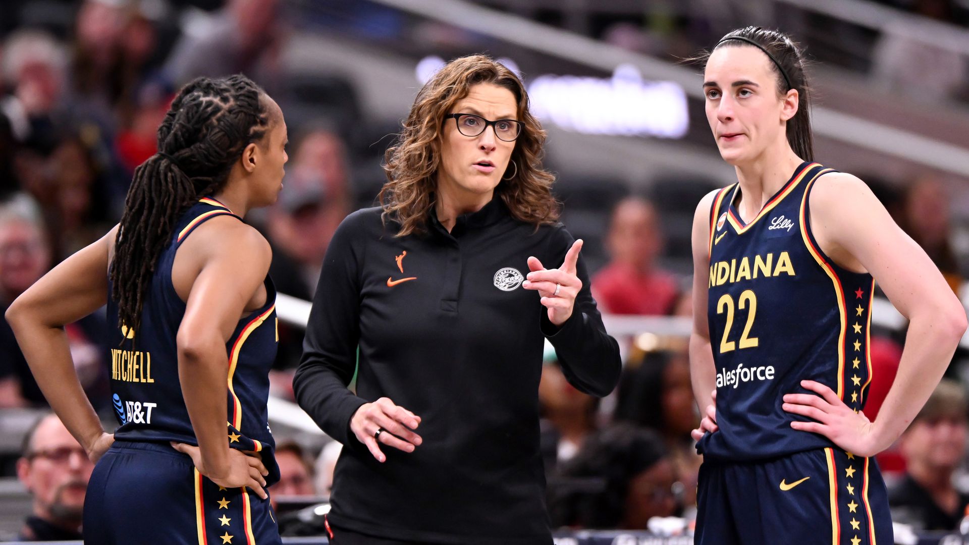 Head coach Stephanie White of the Indiana Fever talks with guard Kelsey Mitchell #0 of the Indiana Fever and guard Caitlin Clark #22 of the Indiana Fever against the Nigeria National Team during the second half at Gainbridge Fieldhouse on May 02, 2026 in Indianapolis, Indiana.
