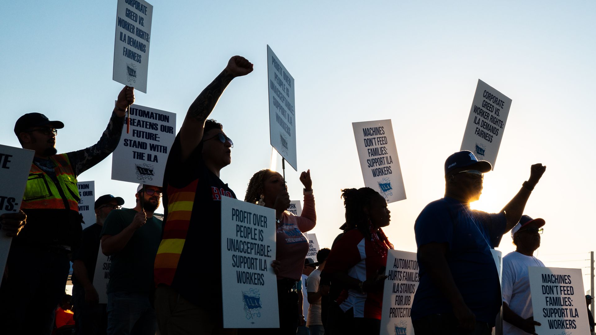 Dockworkers strike and hold signs in a picket line outside of the Port of Houston Authority in Houston, Texas.