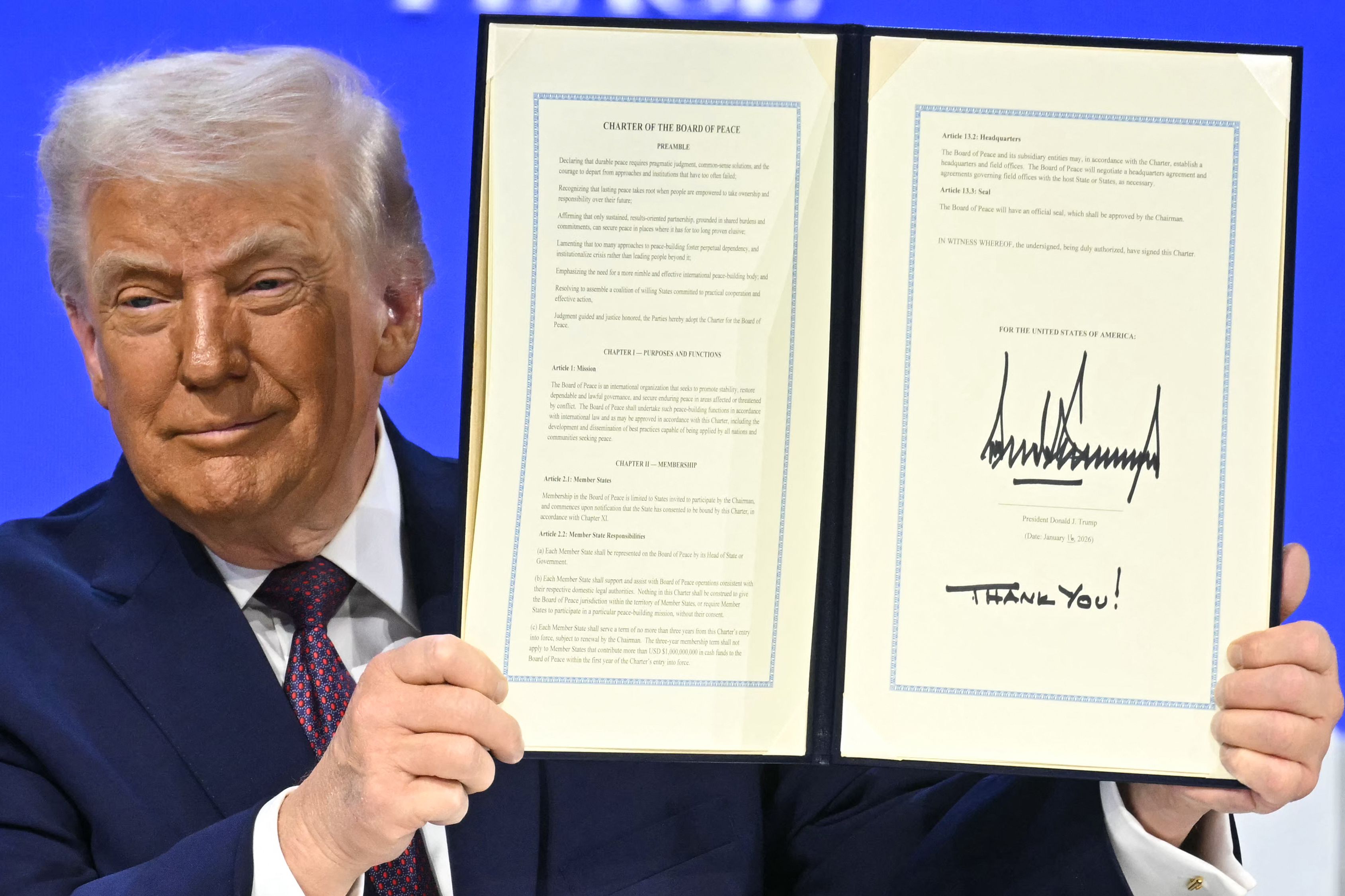 - US President Donald Trump holds a signed founding charter at the "Board of Peace" meeting during the World Economic Forum (WEF) annual meeting in Davos on January 22, 2026. US President Donald Trump will show off his new "Board of Peace" at Davos on January 22, 2026 burnishing his claim to be a pe