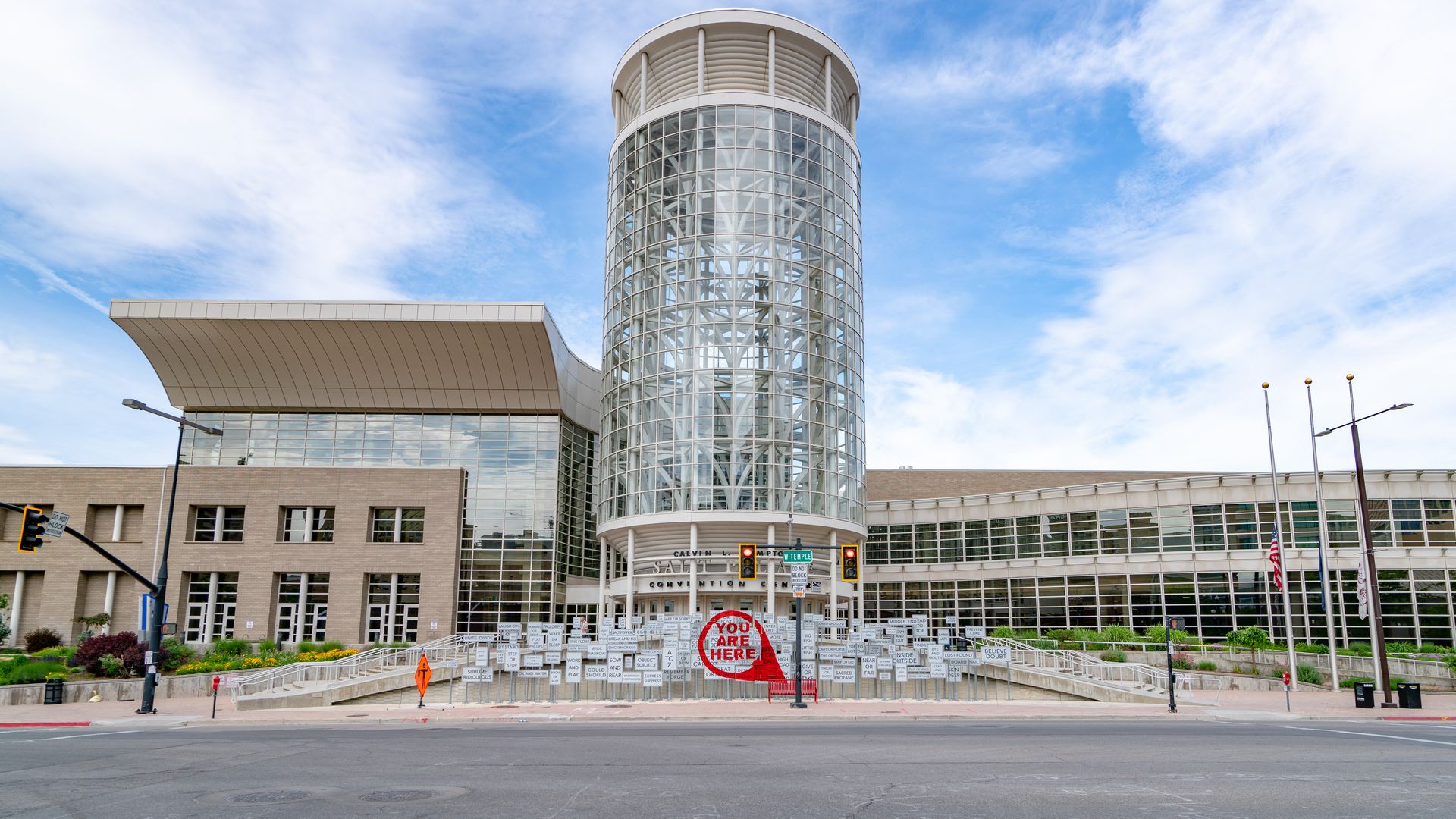The exterior of the Salt Palace Convention Center on a cloudy day.