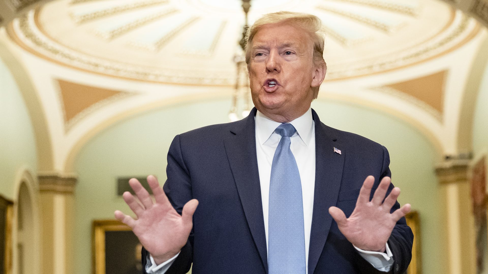 President Donald Trump talks to reporters at the Capitol 