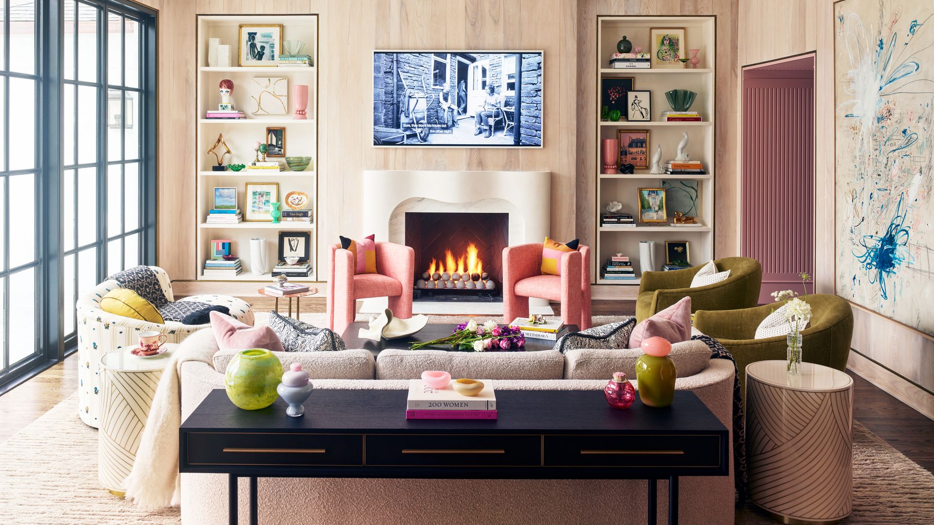 living room with white oak walls, a custom fireplace and luxurious seating