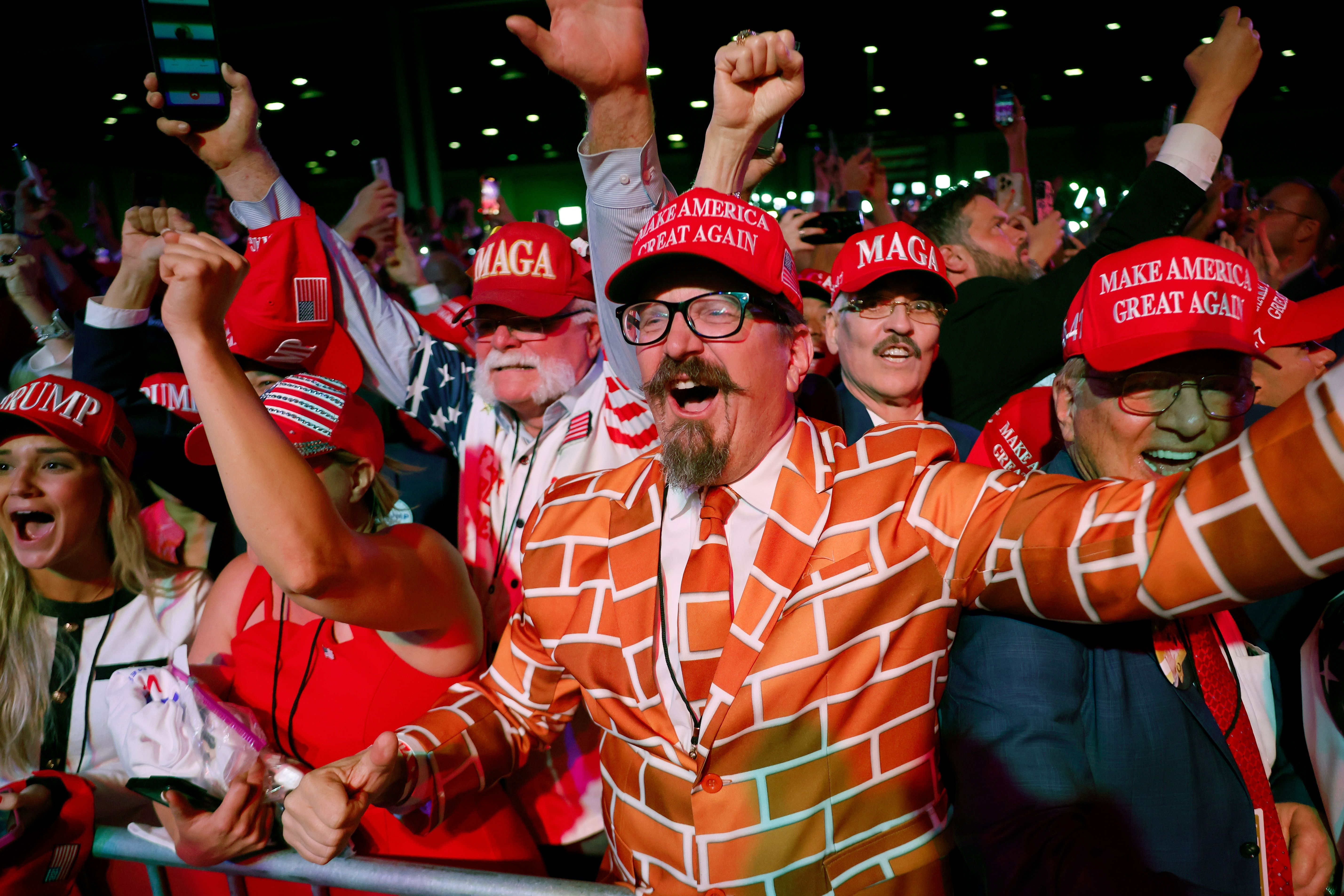   Supporters react as Fox News projects Republican presidential nominee, former U.S. President Donald Trump is elected president during an election night event at the Palm Beach Convention Center on November 06, 2024 in West Palm Beach, Florida.