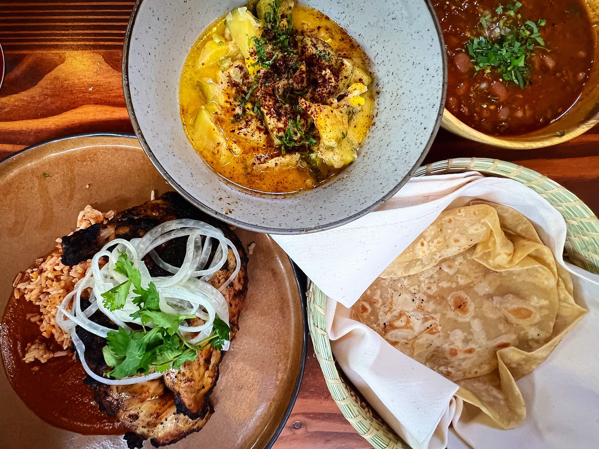 An arrangement of plates filled with Mexican food. 
