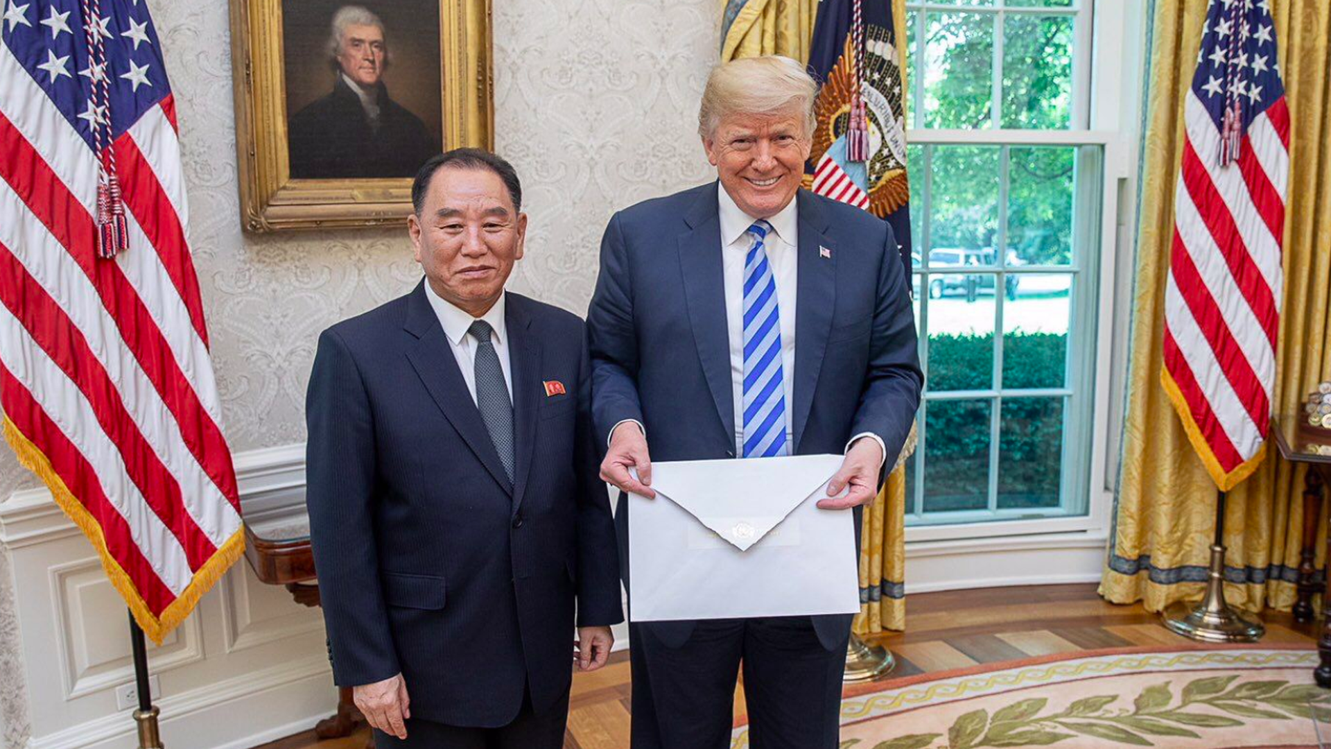 Trump holds a letter from Kim