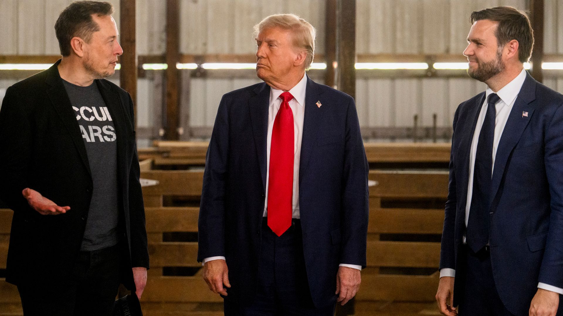 Elon Musk, chief executive officer of Tesla Inc., from left, former US President Donald Trump, and Senator JD Vance, a Republican from Ohio and Republican vice-presidential nominee, prior to a campaign event at the Butler Farm Show in Butler, Pennsylvania, US, on Saturday, Oct. 5, 2024.
