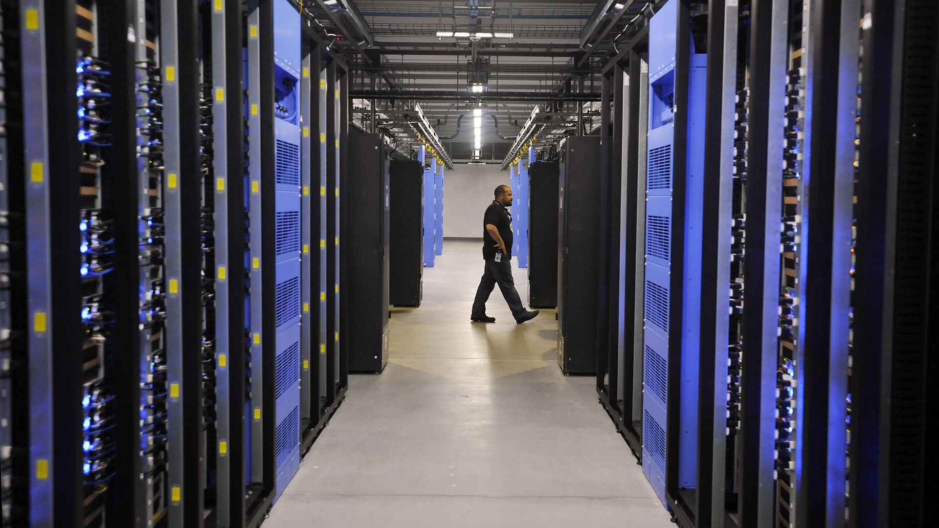 FOREST CITY, NC - APRIL 19: An employee walks past servers in one of four server rooms at the new Facebook Data Center on April 19, 2012 in Forest City, North Carolina. The company began construction on the facility in November 2010 and went live today, serving the 845 million Facebook users worldwi