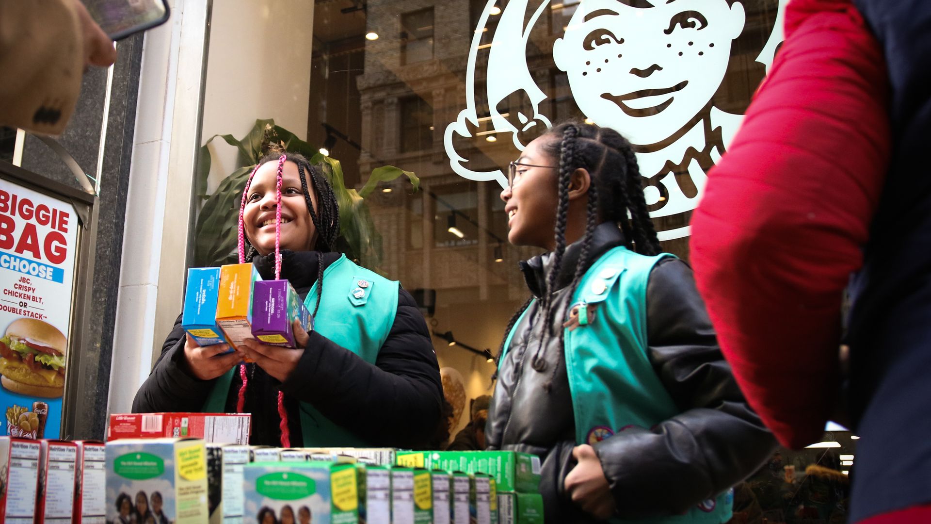 Wendy's storefront with Girl Scouts selling cookies in front