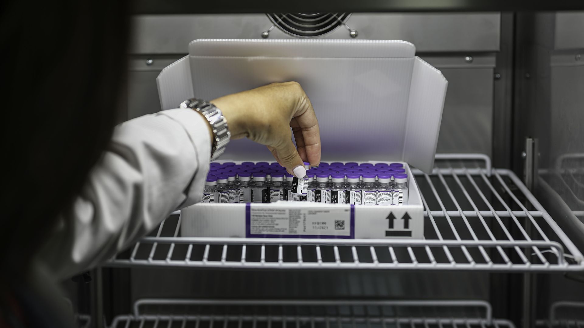 Photo of a nurse holding a vaccine box
