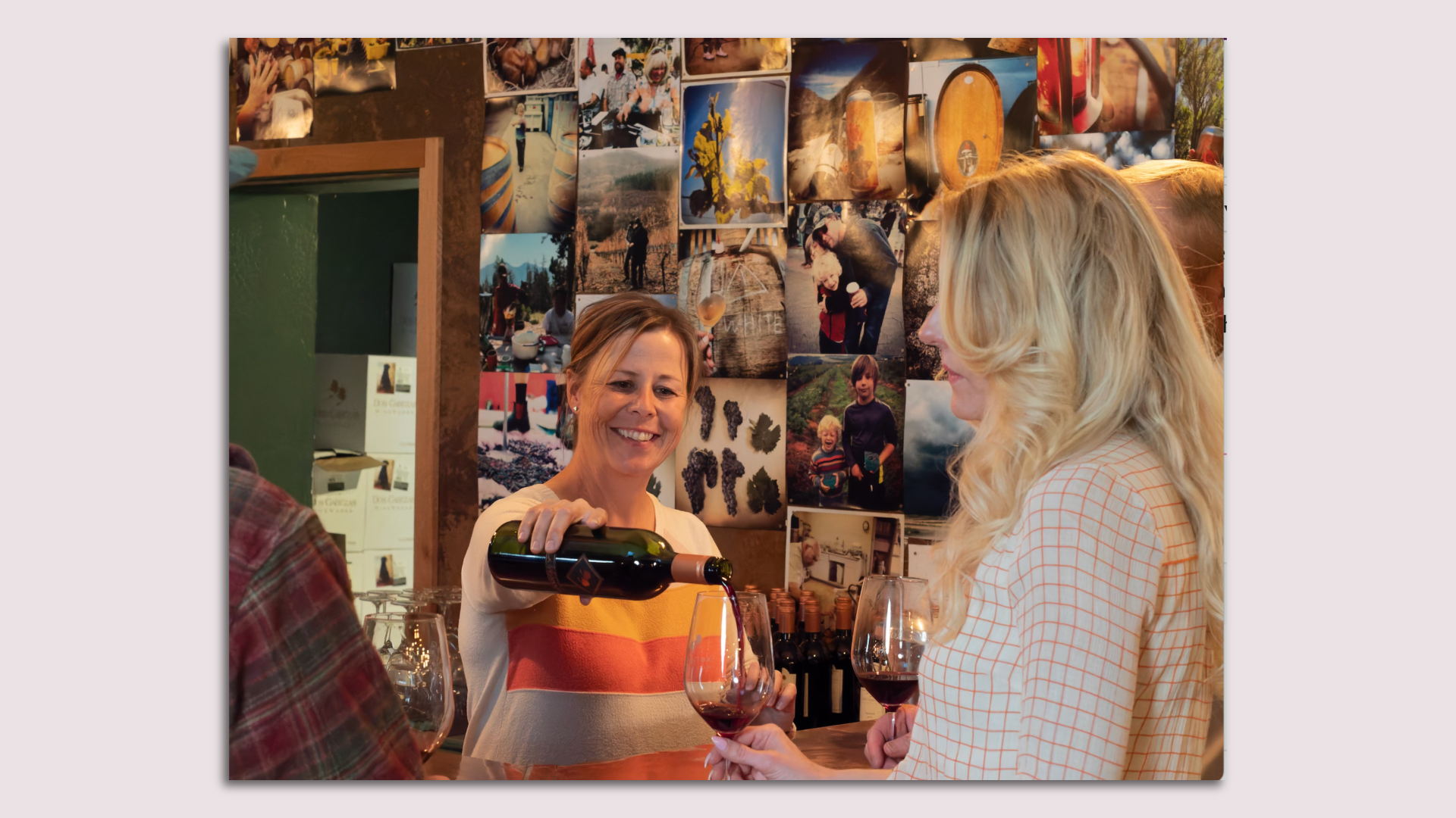 A woman pouring a glass of red wine.