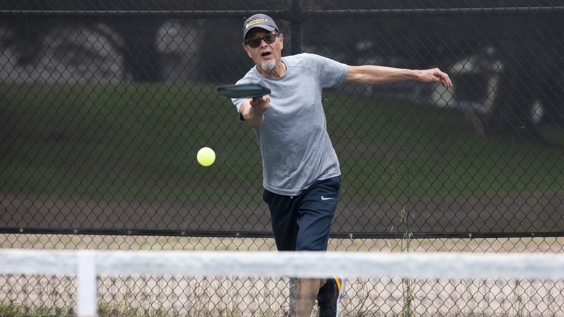 Pickleball player serves