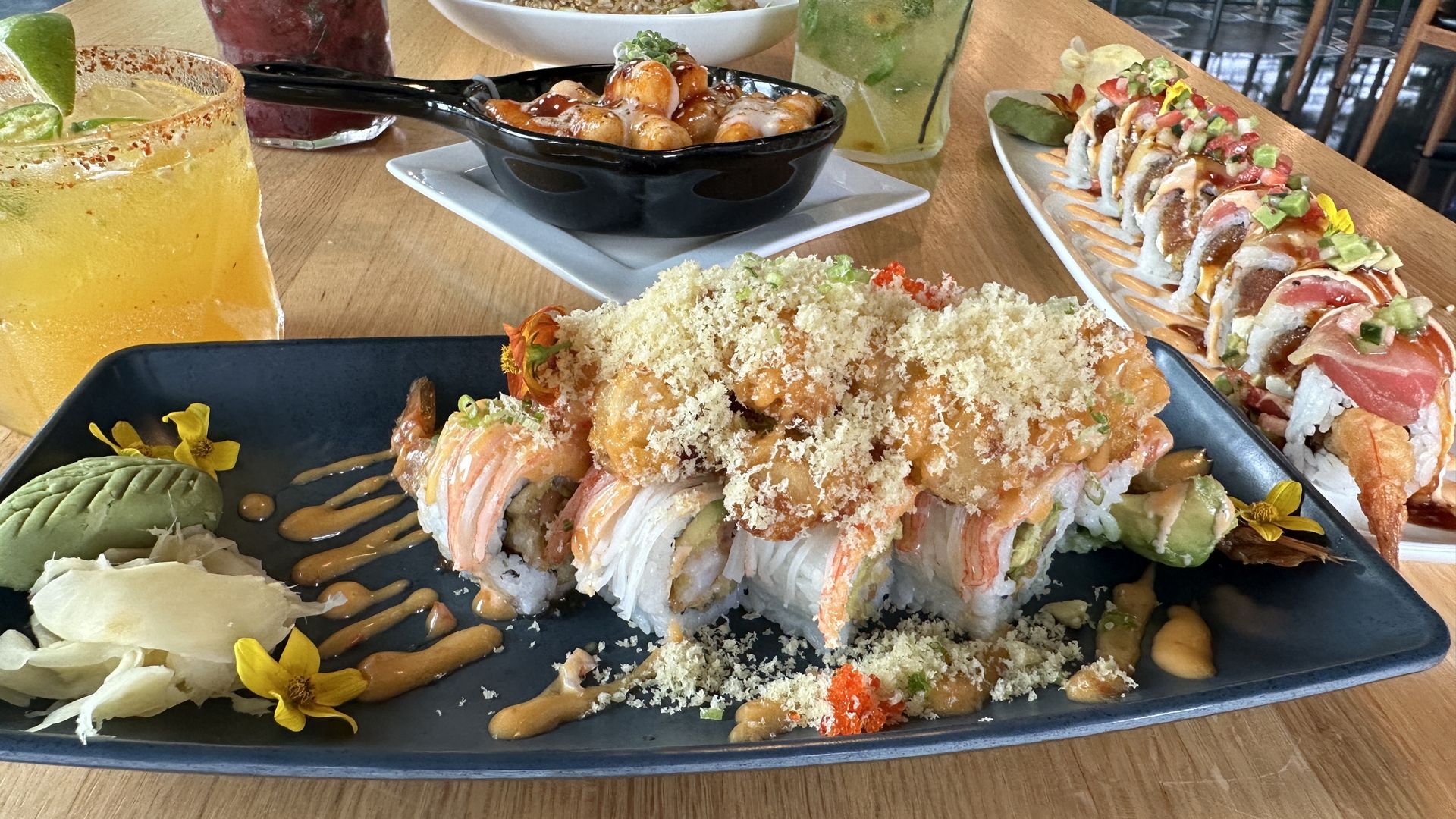 assortment of sushi rolls and drinks