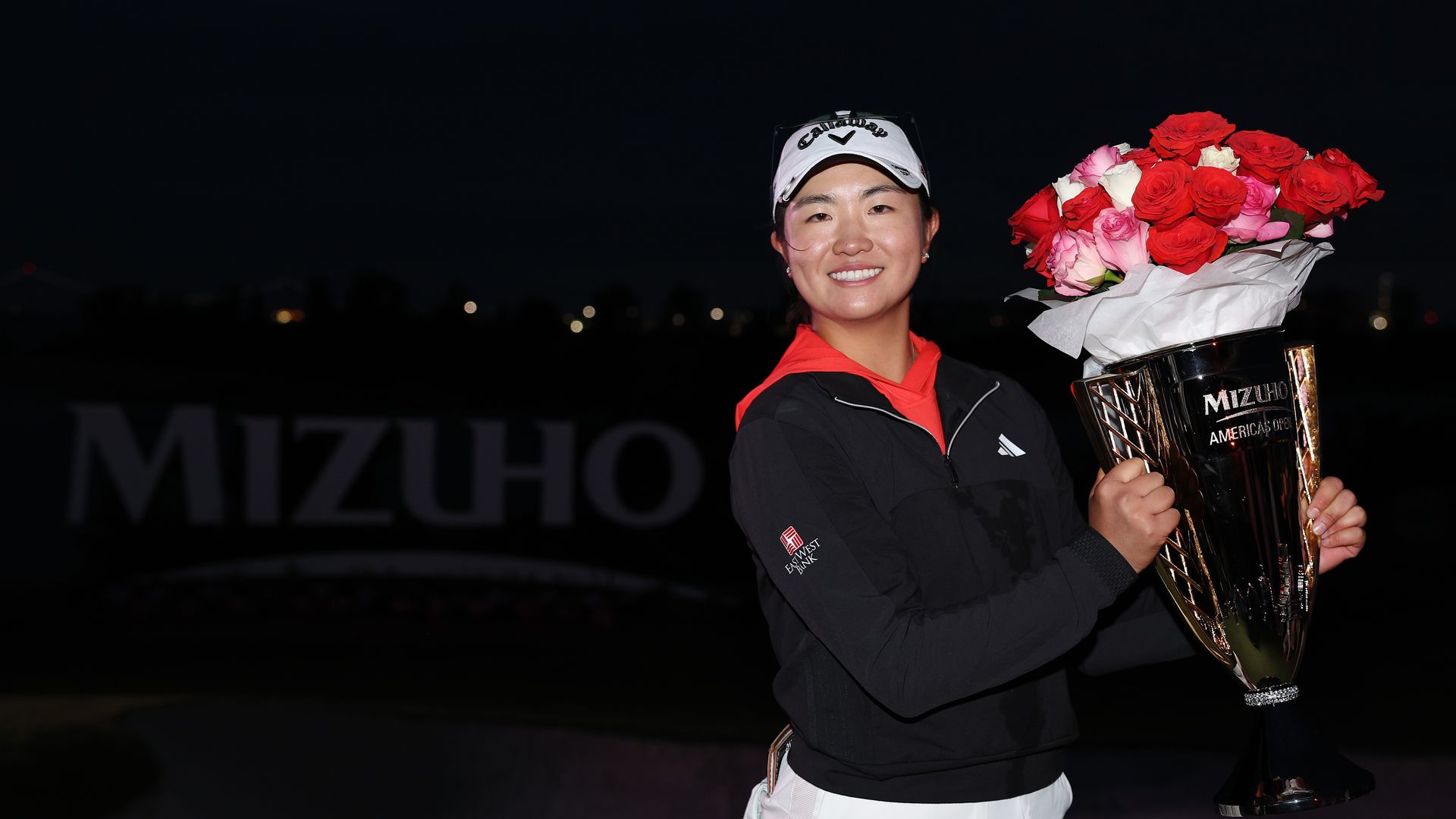 rose zhang holds flowers and trophy