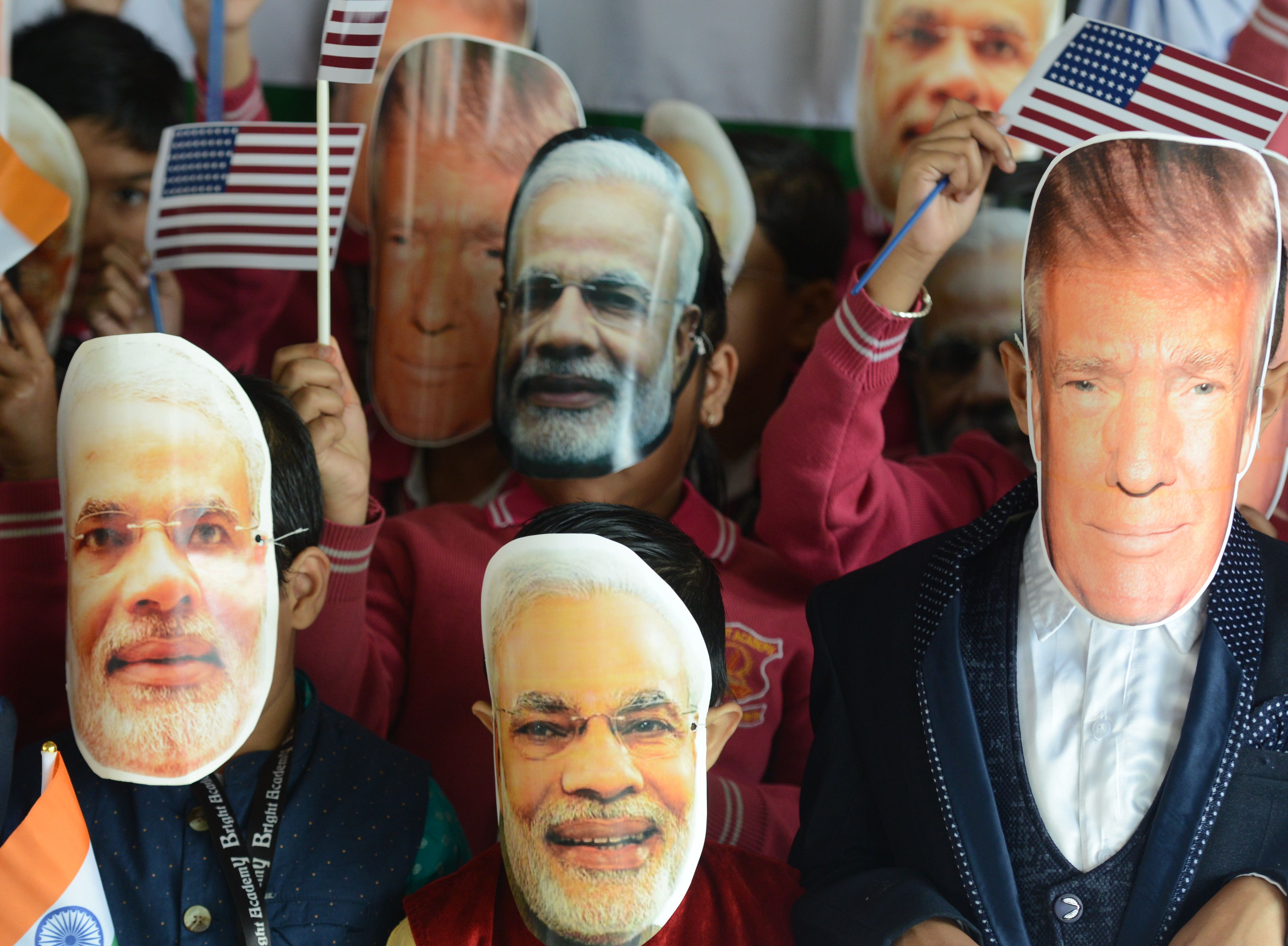 Indian school children wearing masks of Indian Prime Minister Narendra Modi and US President Donald Trump pose for a picture at Bright Academy school in Siliguri 