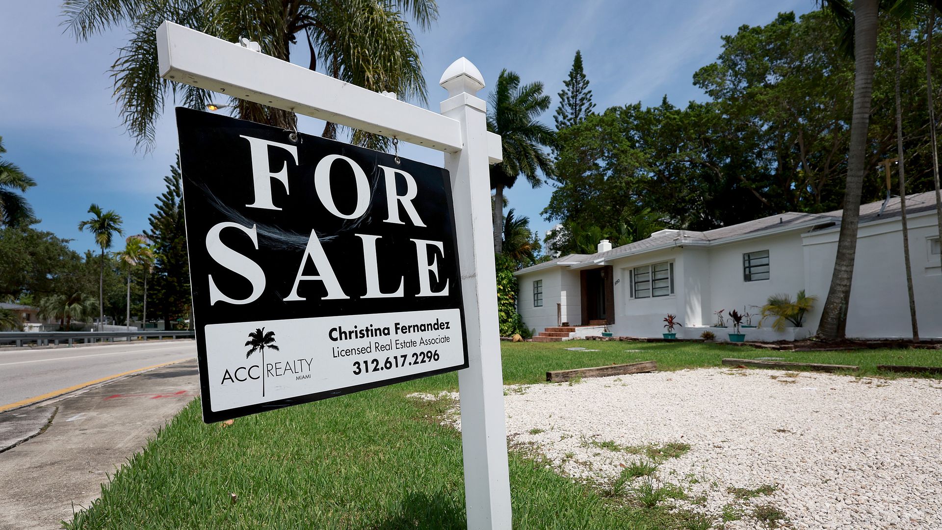 A 'for sale' sign hangs in front of a home on June 21, 2022 in Miami, Florida.